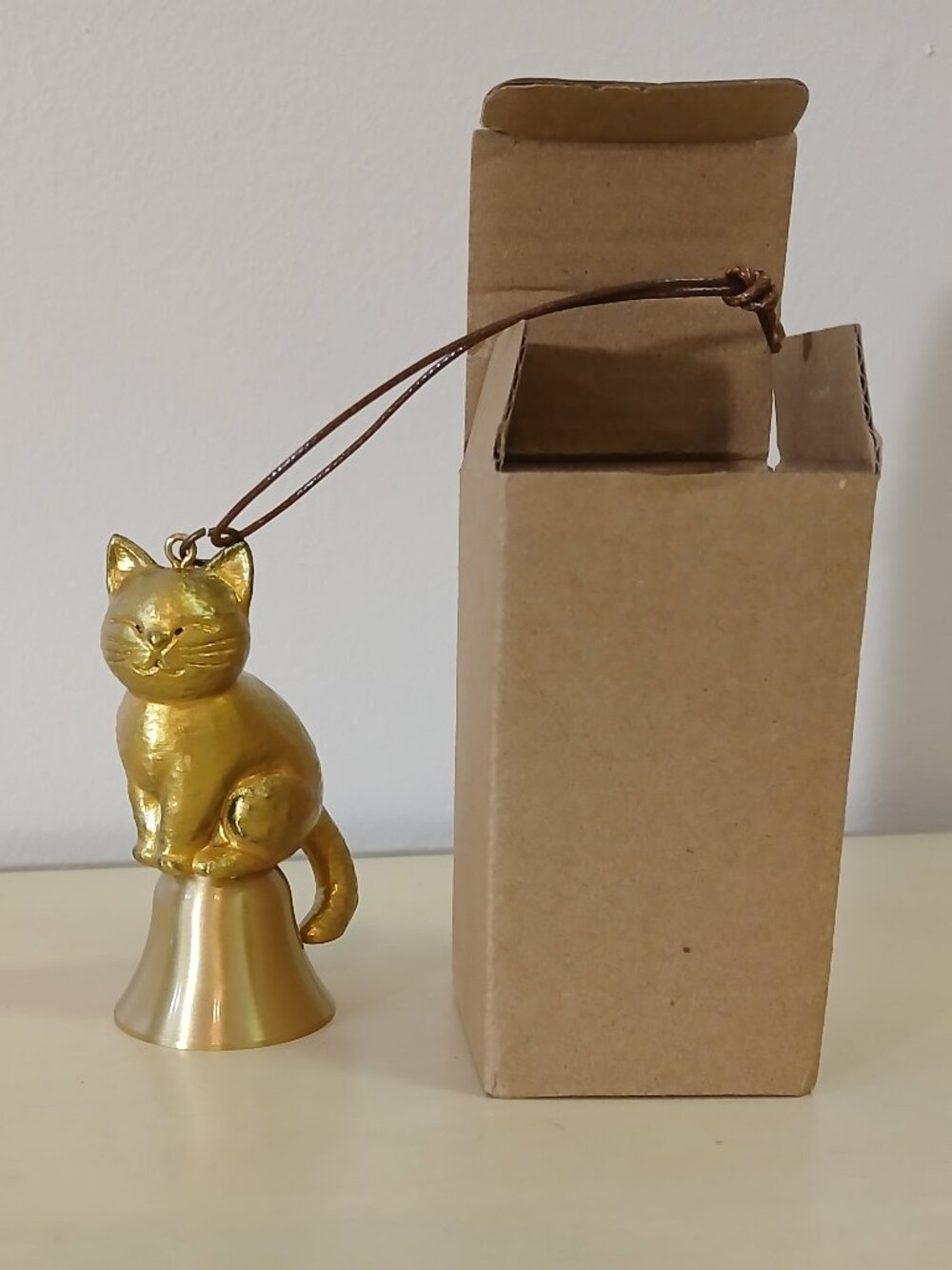 Small gold cat bell with cord hanger - 3 inches